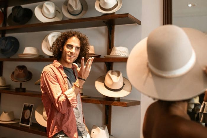 a business man selling hats and attracting more business from a great website